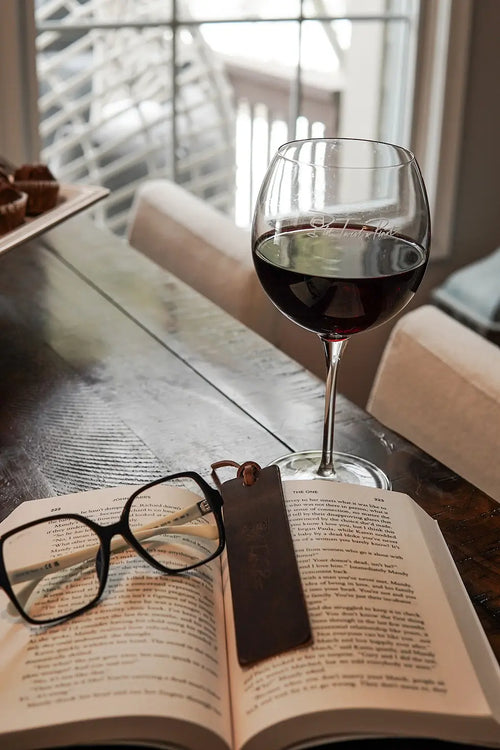 A pinot noir wine glass and a leather bookmark gift set for book lovers.