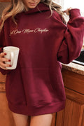 A woman wearing a maroon hoodie with the words "Just One More Chapter" in a script font across the chest area.