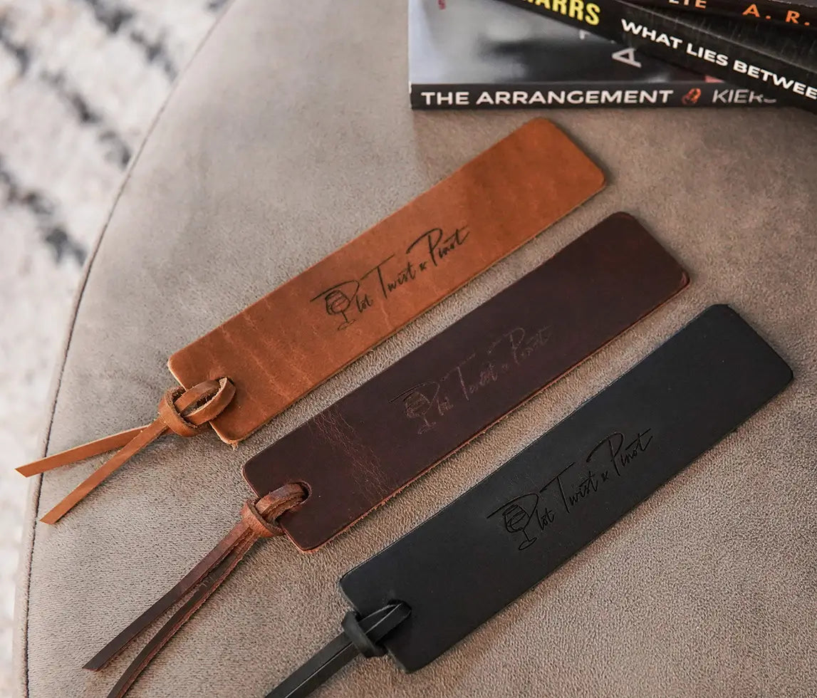 Another shot of the three colors available for these leather bookmarks with 'Plot Twist and Pinot' branding on them.