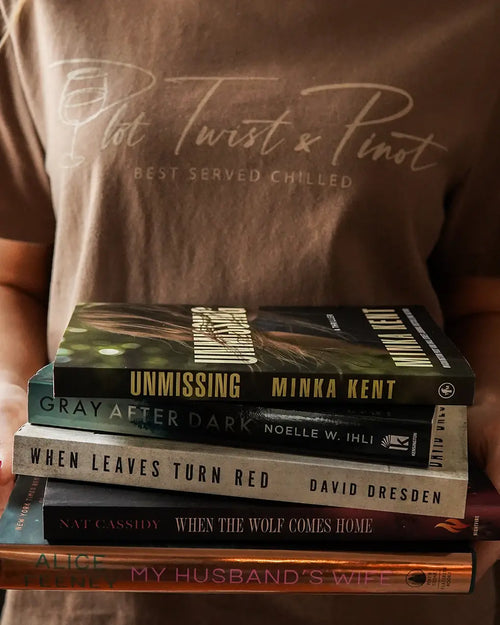Woman wearing a vintage brown color of the t-shirt design holding a stack of books.